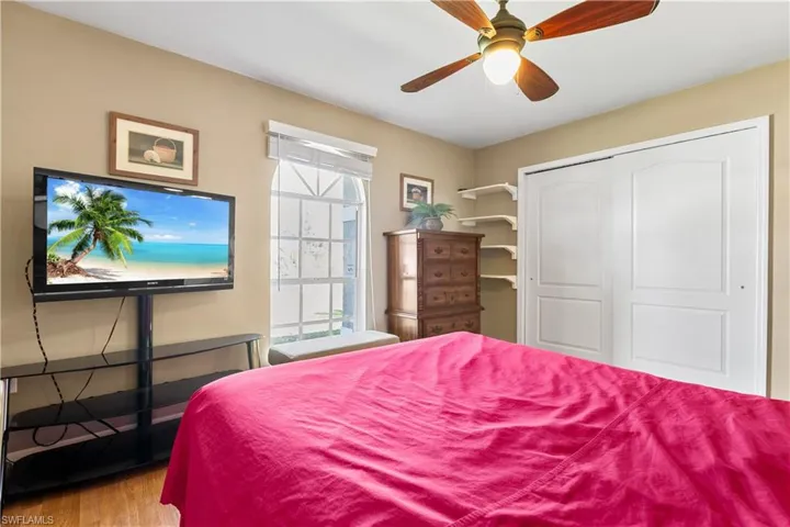 Bedroom featuring light hardwood / wood-style floors, a closet, and ceiling fan