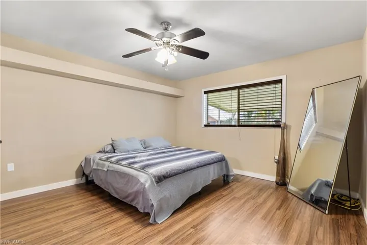 Bedroom with ceiling fan and light hardwood / wood-style flooring