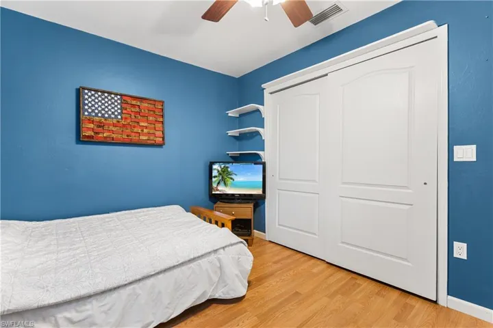 Bedroom featuring light hardwood / wood-style flooring, a closet, and ceiling fan