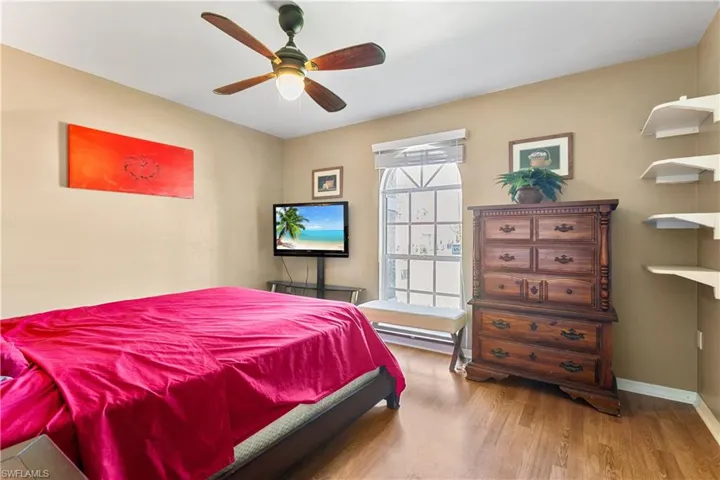 Bedroom with hardwood / wood-style flooring and ceiling fan