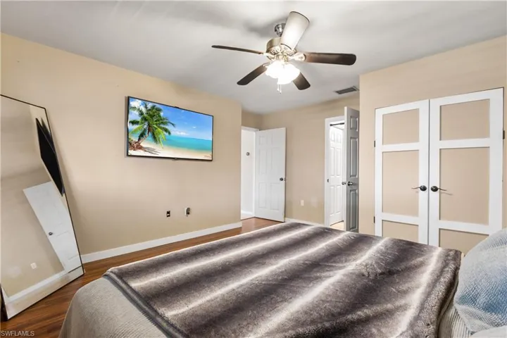 Bedroom featuring hardwood / wood-style flooring, french doors, and ceiling fan