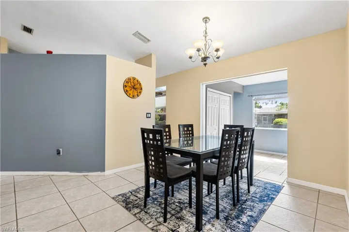 Dining area featuring an inviting chandelier and light tile patterned floors