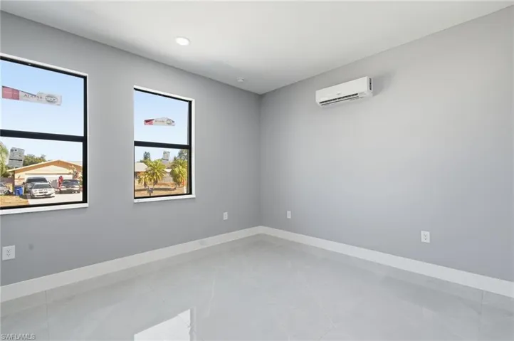 Spare room with baseboards and a wall mounted mini split