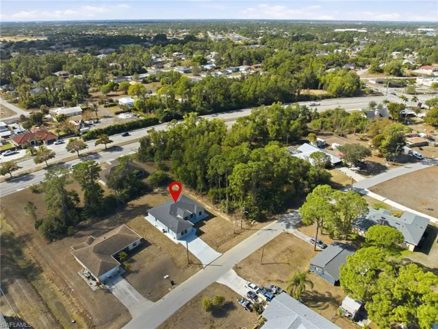 Aerial view of property's location with nearby suburban area