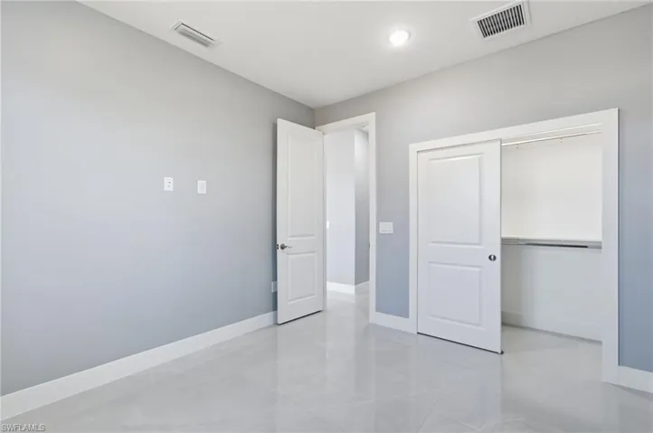 Unfurnished bedroom with baseboards and a closet