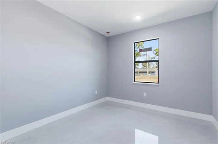 Unfurnished room with baseboards