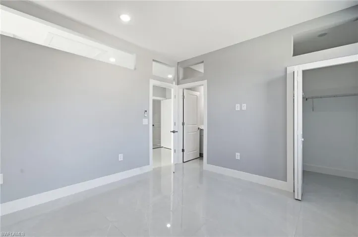 Unfurnished bedroom featuring a spacious closet and recessed lighting