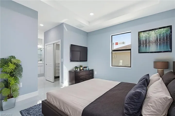 Bedroom with a closet, ensuite bathroom, and recessed lighting