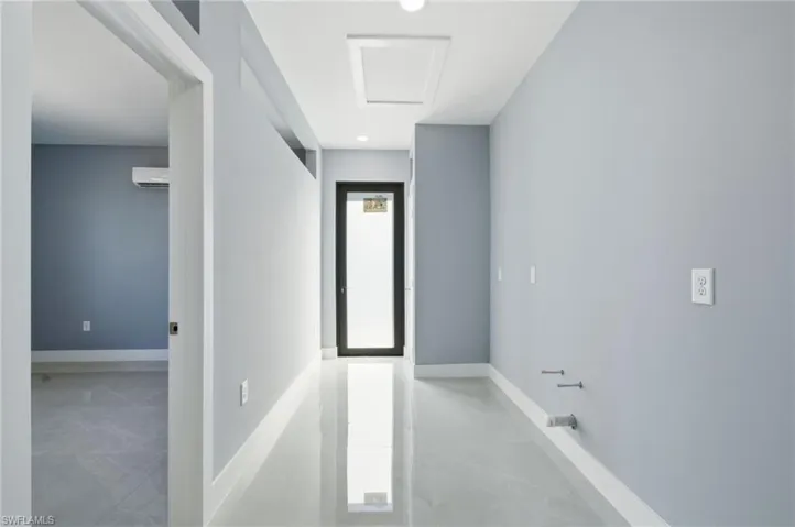 Corridor featuring recessed lighting and light tile patterned floors
