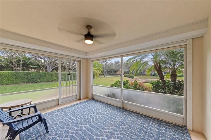 Unfurnished sunroom featuring ceiling fan and healthy amount of natural light