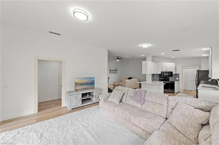 Living room featuring light wood-style floors and ceiling fan
