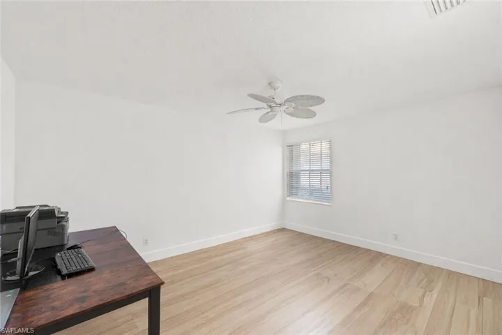 Unfurnished office featuring light wood finished floors and ceiling fan