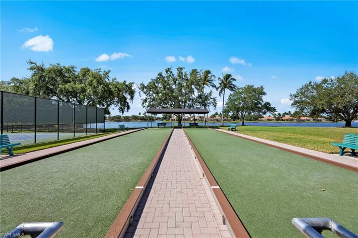 View of home's community featuring a game area and a water view