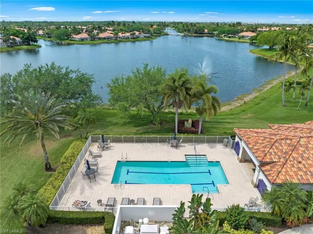 Community pool with a patio and a water view