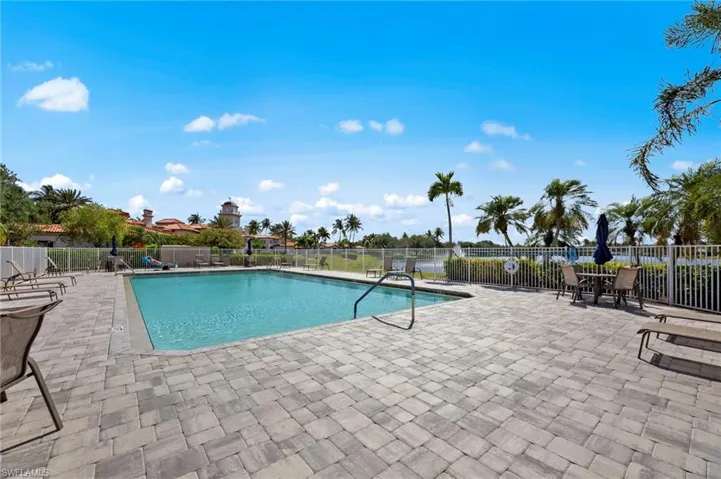 Community pool with a patio
