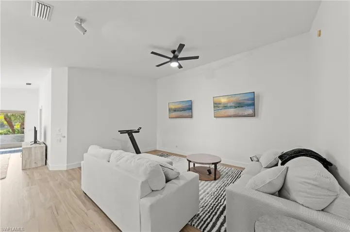 Living area featuring light wood finished floors and ceiling fan