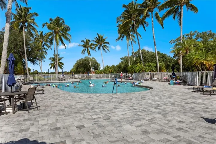 Community pool featuring a patio