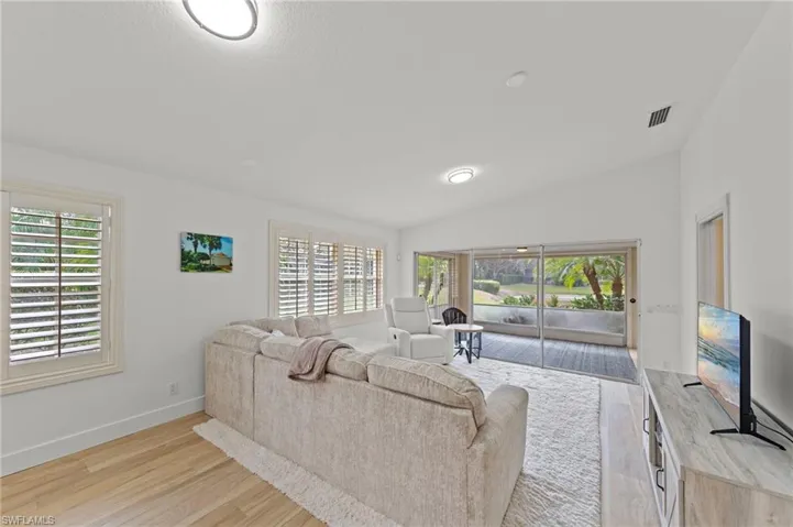 Living room featuring lofted ceiling and light wood-type flooring