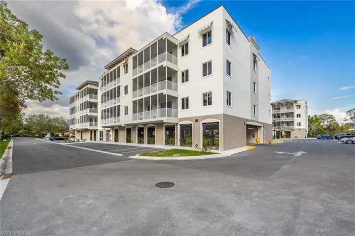 View of property featuring uncovered parking