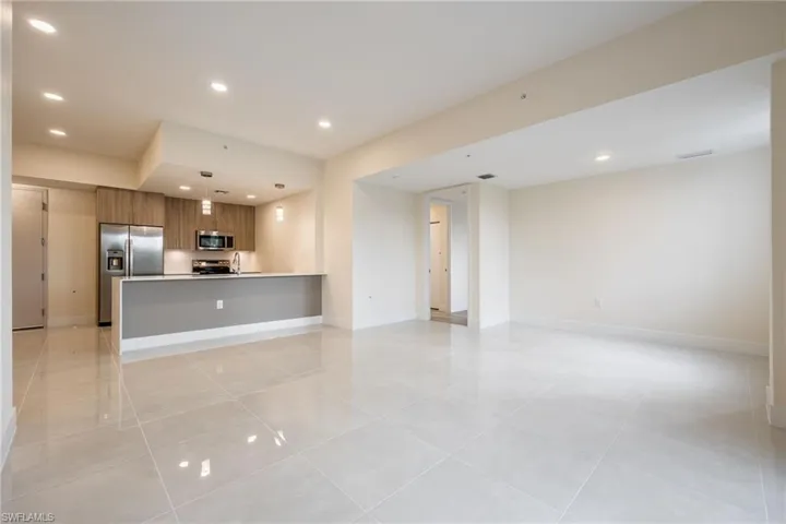 Unfurnished living room with baseboards, recessed lighting, and light tile patterned floors
