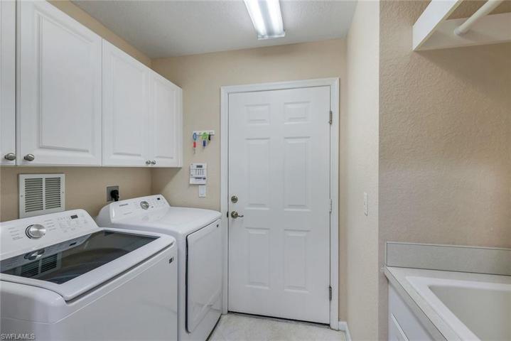 Laundry Mud room with cabinets, sink and leading to 2 car garage