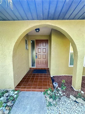 Entrance to property featuring stucco siding
