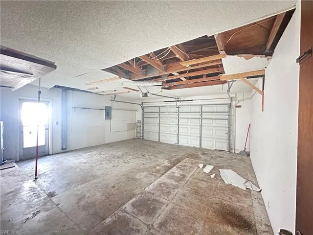 Garage featuring electric panel and a garage door opener