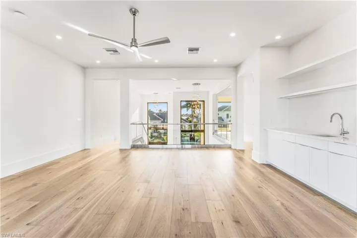 Unfurnished living room with a ceiling fan, light wood-style flooring, and recessed lighting