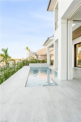View of swimming pool with patio surround