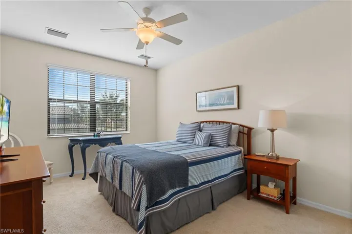 Bedroom featuring ceiling fan and light carpet
