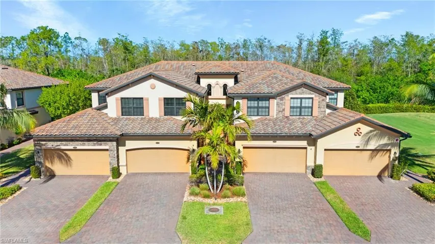 Mediterranean / spanish house with a garage and a front yard