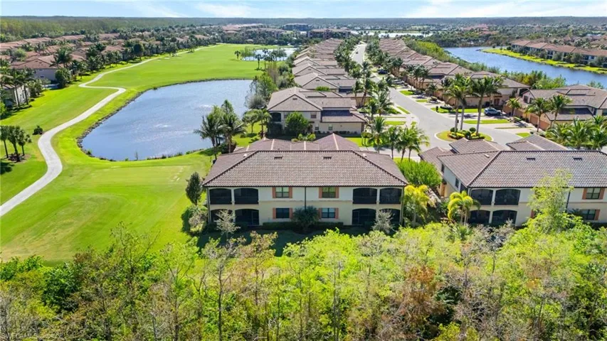 Birds eye view of property with a water view