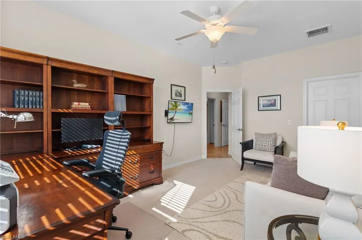 Carpeted office with ceiling fan