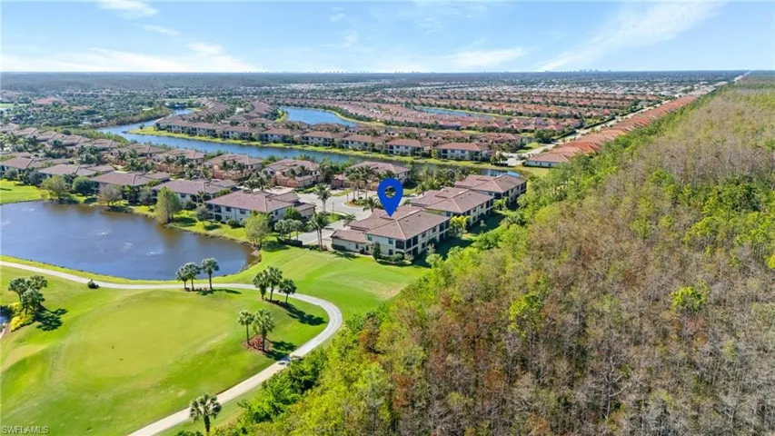 Birds eye view of property with a water view