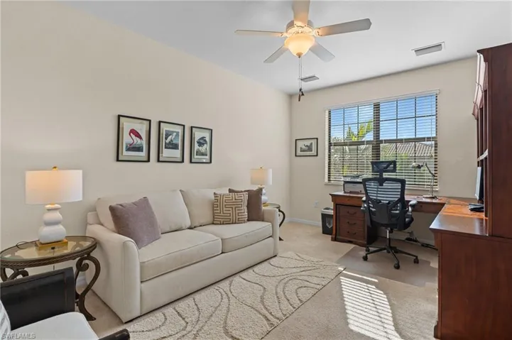 Carpeted office with ceiling fan