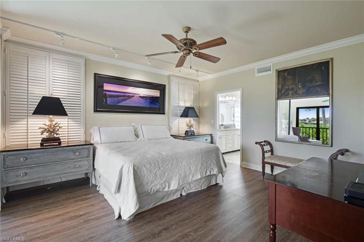 Large and inviting primary bedroom with en suite and sliding doors to allow access to the enclosed lanai.