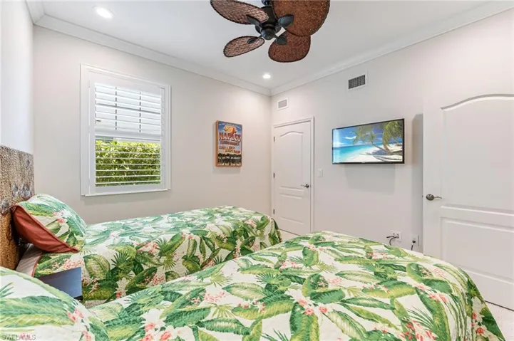 Bedroom with ornamental molding, ceiling fan, recessed lighting, and visible vents