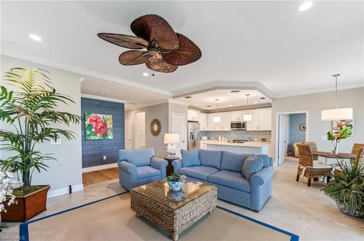 Living area featuring crown molding, baseboards, recessed lighting, and a ceiling fan