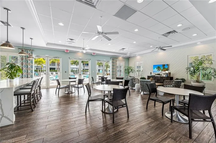 Dining area with a paneled ceiling, french doors, ceiling fan, and visible vents