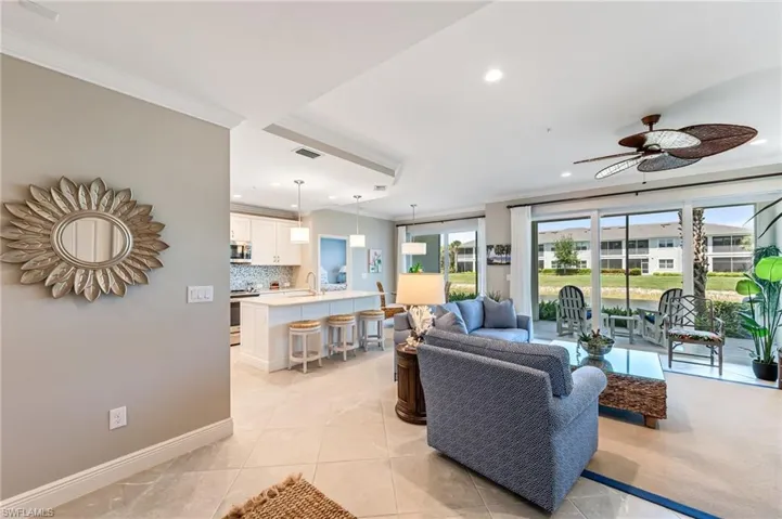 Living room featuring ceiling fan, ornamental molding, and recessed lighting