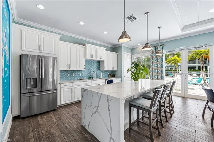 Kitchen with a sink, french doors, white cabinets, and stainless steel appliances