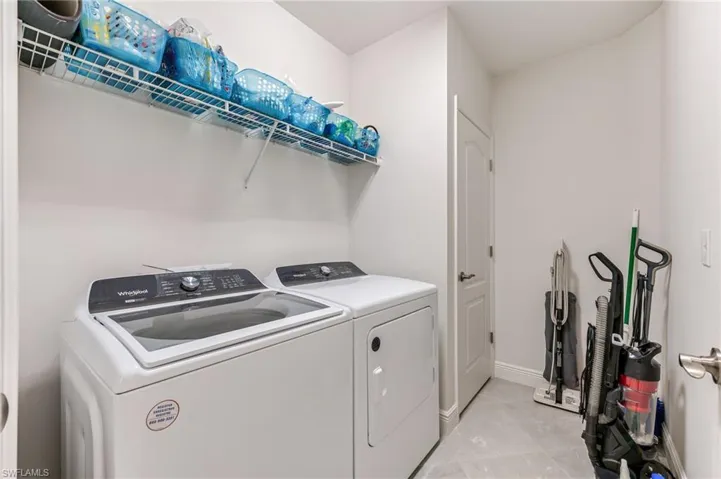 Laundry area featuring separate washer and dryer, laundry area, and baseboards