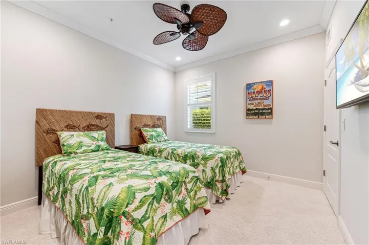 Carpeted bedroom featuring recessed lighting, baseboards, ornamental molding, and a ceiling fan