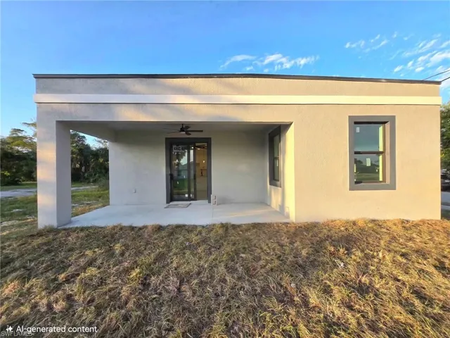 Back of house with a ceiling fan, a patio area, and stucco siding