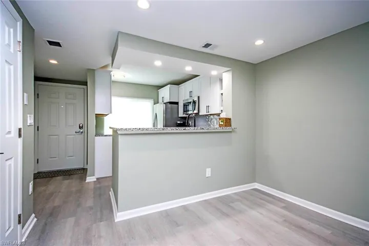 Kitchen with visible vents, recessed lighting, white cabinets, appliances with stainless steel finishes, and wood finished floors