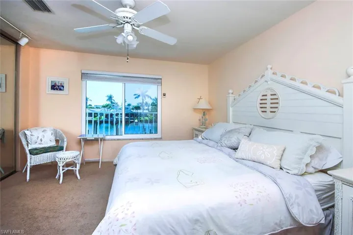 Carpeted bedroom featuring visible vents and ceiling fan
