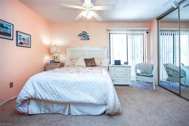 Bedroom with a closet, carpet flooring, and a ceiling fan