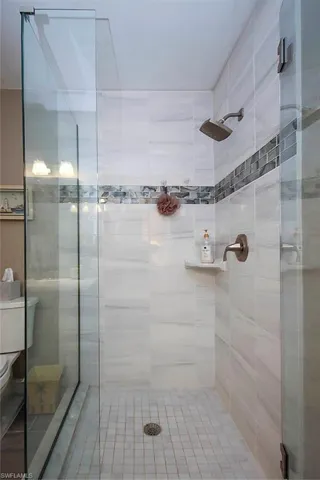 Bathroom with toilet and a stall shower