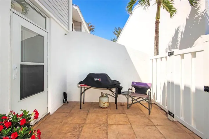View of patio featuring fence