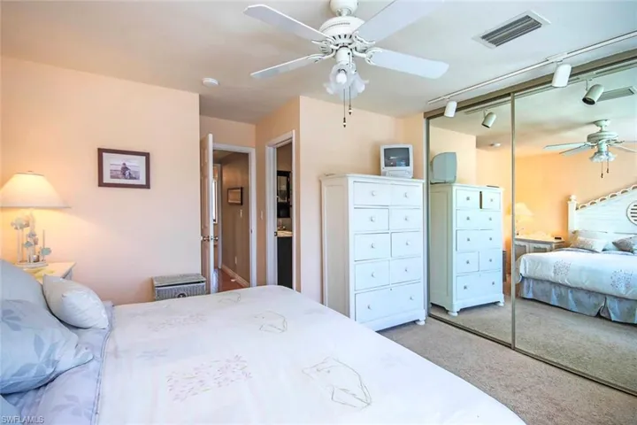 Bedroom featuring carpet, visible vents, a closet, and ceiling fan